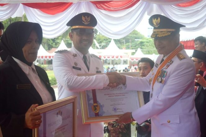 
 Wakil Gubernur Sulteng Mamun Amir saat menyerahkan piagam penghargaan Kecamatan Terbaik kepada Camat Palu Selatan Goenawan, Kamis, 17 Agustus 2023. Foto: Istimewa