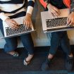 Ilustrasi dua orang memegang Macbook Pro untuk melihat cara cek formasi CPNS 2023 Foto: Pexels
