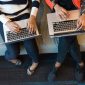 Ilustrasi dua orang memegang Macbook Pro untuk melihat cara cek formasi CPNS 2023 Foto: Pexels